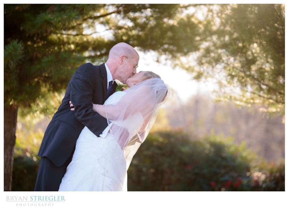 groom dipping bride in front of St. Joseph's